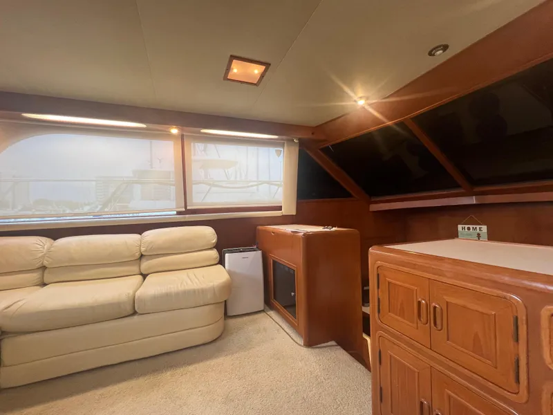 Slide: The Image of Interior of 1990 Pace 42 Motor Yacht with beige sofa and wooden cabinetry. - 16