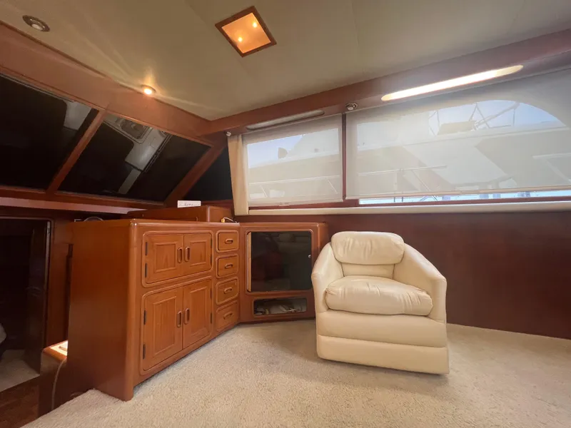Slide: The Image of 1990 Pace 42 Motor Yacht interior with wooden cabinetry and a plush white chair. - 18
