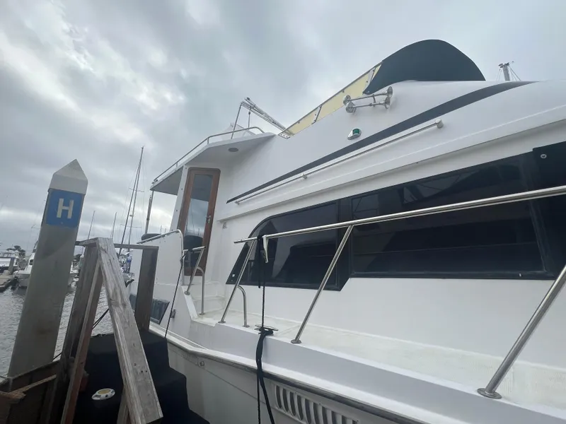 Slide: The Image of 1990 Pace 42 Motor Yacht docked under cloudy skies. - 2