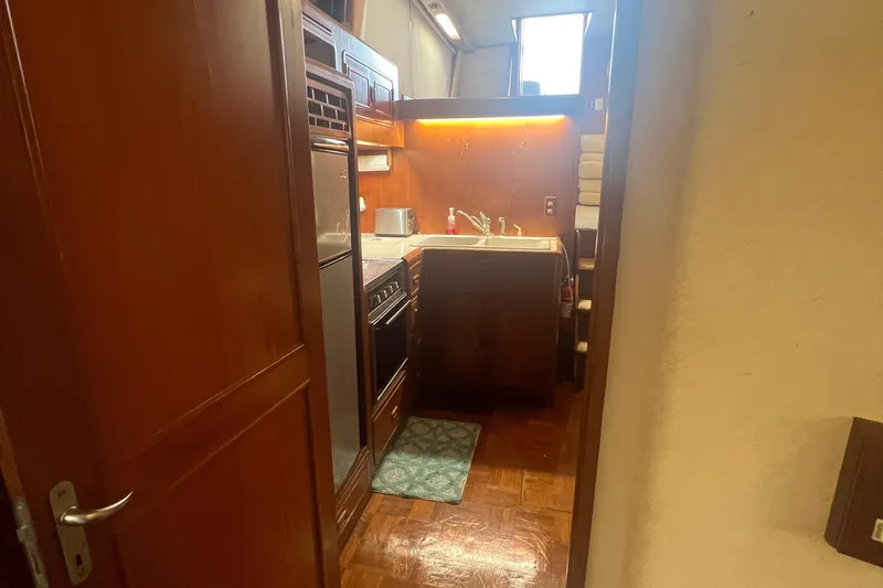 Slide: The Image of 1990 Pace 42 Motor Yacht kitchen with wood cabinetry and modern appliances. - 22