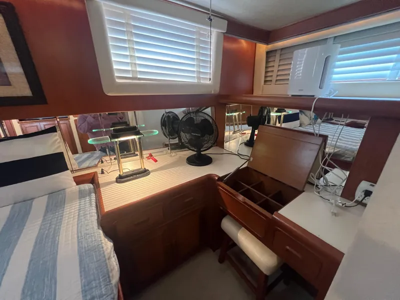 Slide: The Image of 1990 Pace 42 Motor Yacht interior with desk, fan, and striped bedding. - 26
