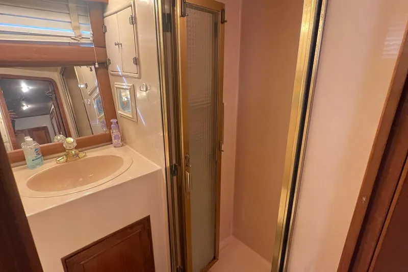 Slide: The Image of 1990 Pace 42 Motor Yacht bathroom with sink, mirror, and shower. - 34