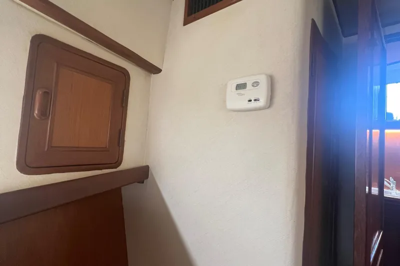 Slide: The Image of Interior of 1990 Pace 42 Motor Yacht with thermostat and wooden cabinetry. - 37