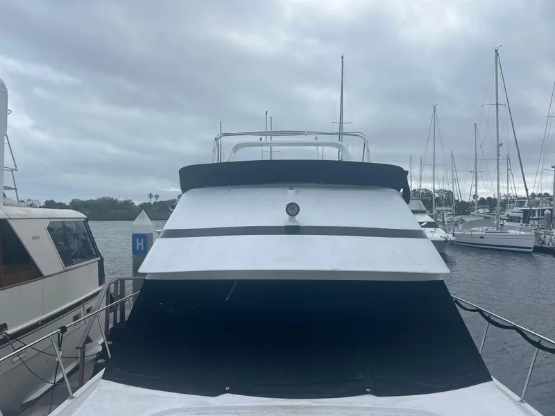 Slide: The Image of 1990 Pace 42 Motor Yacht docked at marina under cloudy skies. - 4