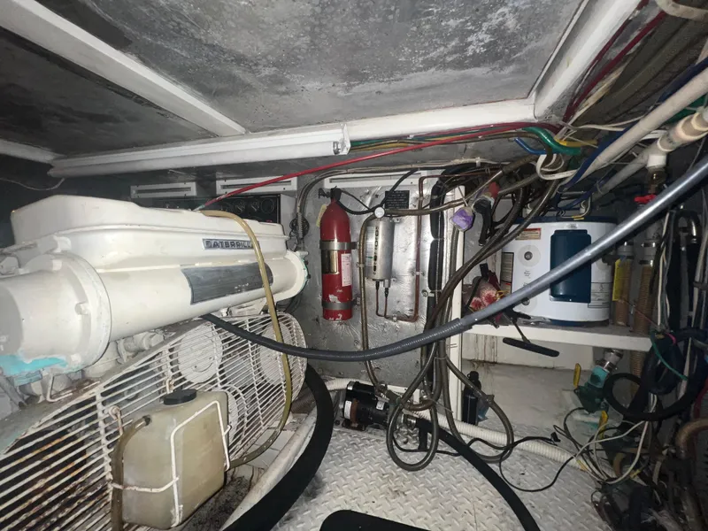 Slide: The Image of Engine room of a 1990 Pace 42 Motor Yacht with visible machinery and wiring. - 43