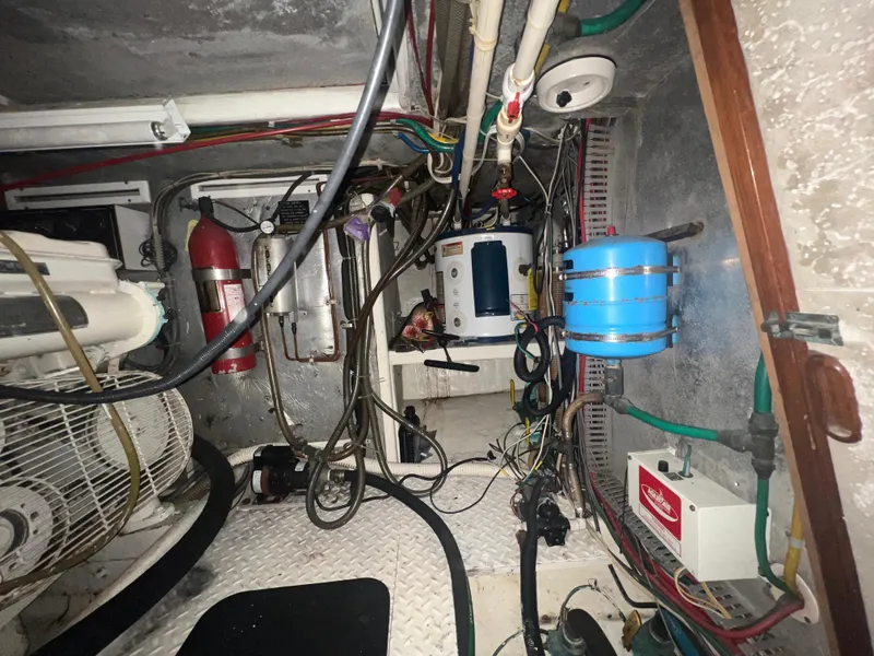 Slide: The Image of Engine room of a 1990 Pace 42 Motor Yacht with various equipment and wiring. - 46