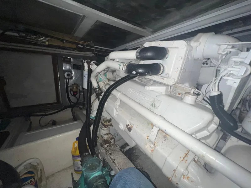 Slide: The Image of Engine room of a 1990 Pace 42 Motor Yacht, showcasing mechanical components and piping. - 47