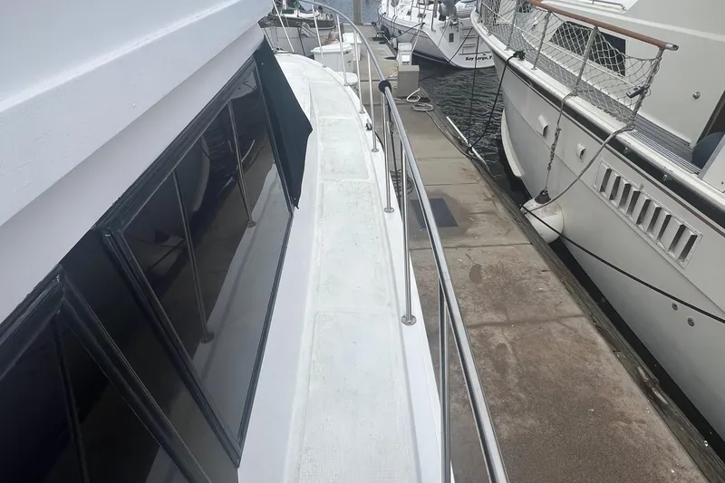 Slide: The Image of 1990 Pace 42 Motor Yacht docked alongside other boats. - 5