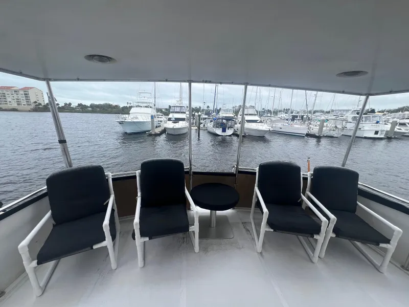 Slide: The Image of 1990 Pace 42 Motor Yacht deck with chairs, overlooking marina and boats. - 7