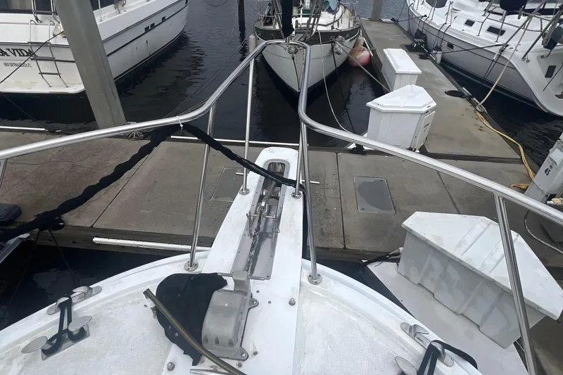 Slide: The Image of Bow view of a 1990 Pace 42 Motor Yacht docked at a marina. - 9