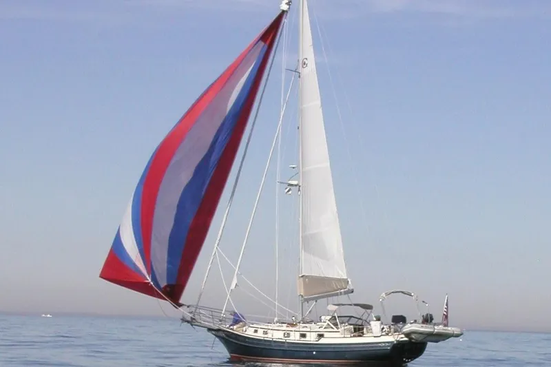 The Image of 2000 Gozzard 37 sailboat with colorful spinnaker on calm sea. - 1