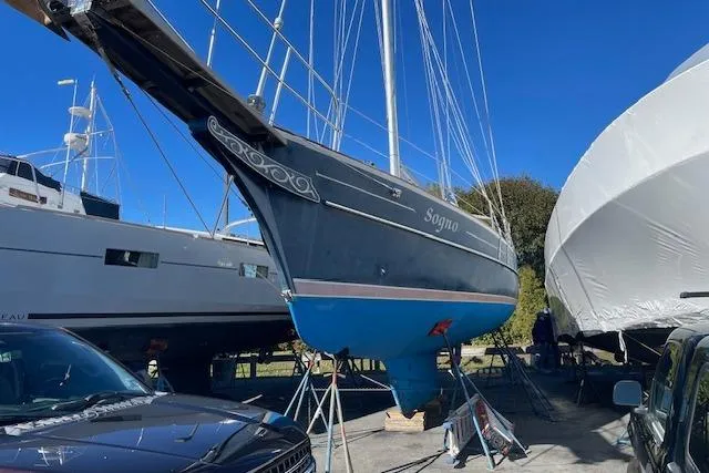Slide: The Image of Gozzard 37 sailboat from 2000 on dry dock, surrounded by other boats. - 11