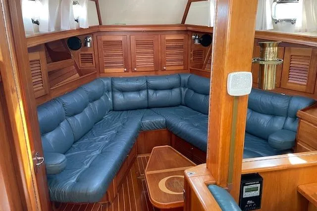 Slide: The Image of Luxurious interior of 2000 Gozzard 37 yacht with blue leather seating and wooden finishes. - 14