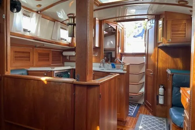 Slide: The Image of Interior of 2000 Gozzard 37 sailboat with wooden cabinetry and cozy seating area. - 24