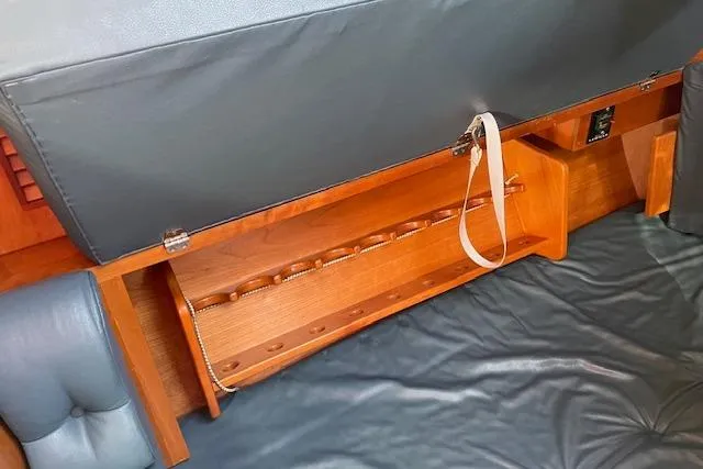 Slide: The Image of Interior view of 2000 Gozzard 37 sailboat with wooden storage compartment. - 26