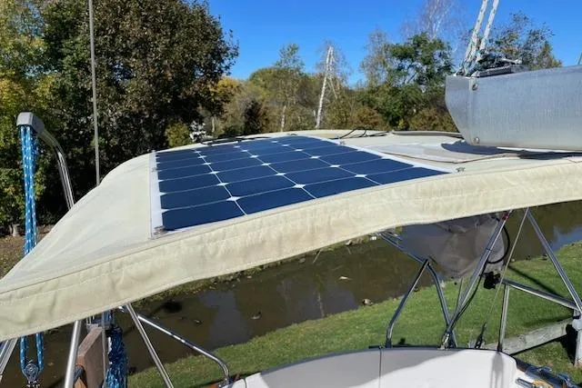 Slide: The Image of Solar panels on a 2000 Gozzard 37 sailboat, docked near a scenic waterway. - 33