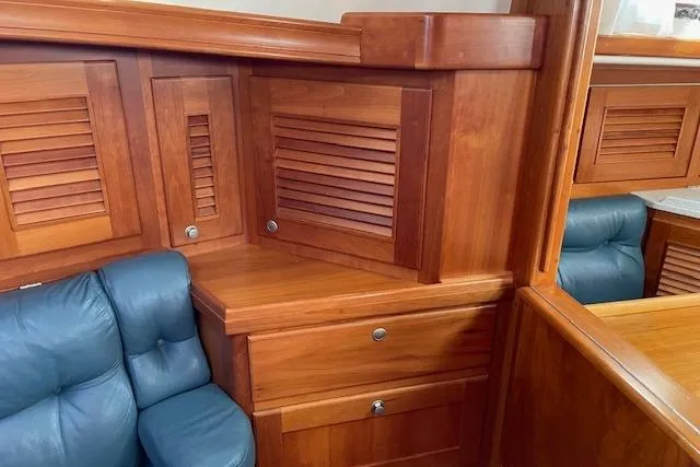 Slide: The Image of Interior of 2000 Gozzard 37 yacht with wooden cabinetry and blue seating. - 17