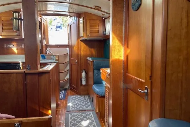 Slide: The Image of Interior of 2000 Gozzard 37 sailboat with wooden cabinetry and seating. - 21