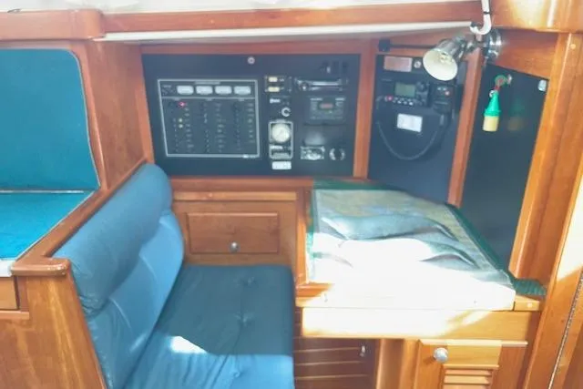 Slide: The Image of Navigation station of 2000 Gozzard 37 sailboat with control panel and seating. - 28