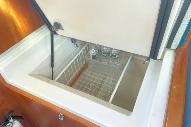 Slide: The Image of Open storage compartment in 2000 Gozzard 37 yacht with water bottles inside. - 29