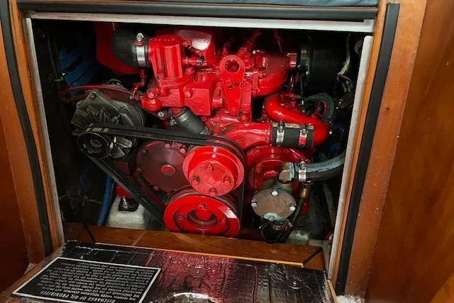 Slide: The Image of Engine compartment of a 2000 Gozzard 37 sailboat, featuring a vibrant red engine. - 30