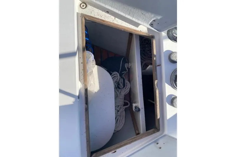 Slide: The Image of Open storage compartment on a 2000 Gozzard 37 sailboat, containing ropes and equipment. - 7