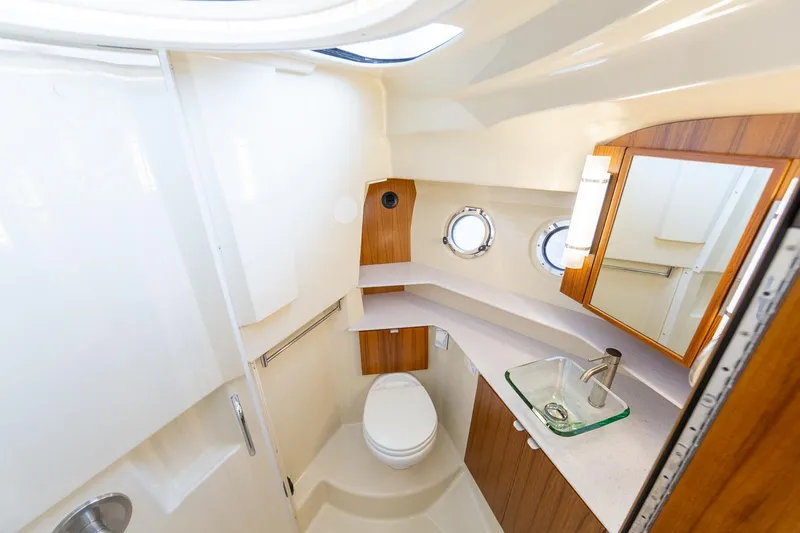 Slide: The Image of Manufacturer Provided Image: Luxurious bathroom in 2025 Ranger Tugs R-43 CB yacht with modern fixtures and porthole windows. - 14