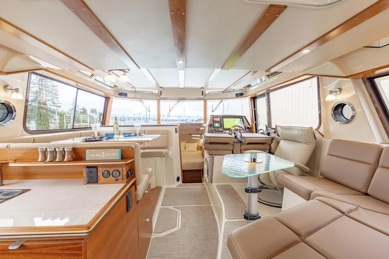 Slide: The Image of Manufacturer Provided Image: Luxurious interior of 2025 Ranger Tugs R-43 CB yacht with modern amenities and seating. - 6