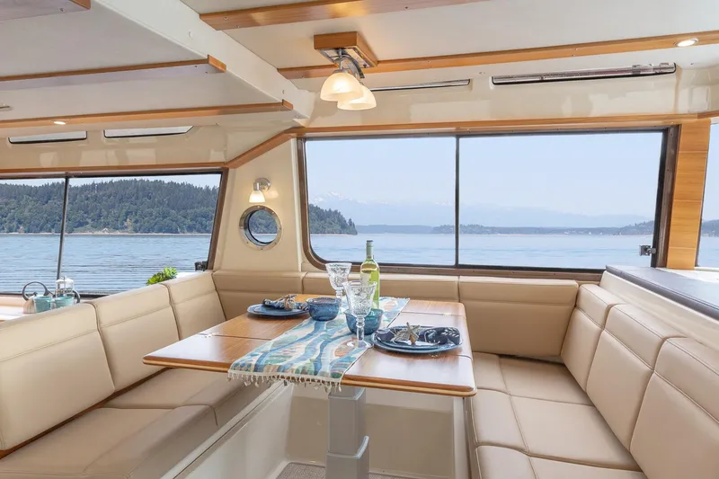 Slide: The Image of Manufacturer Provided Image: Luxurious interior of 2025 Ranger Tugs R-43 CB yacht with scenic ocean view. - 7