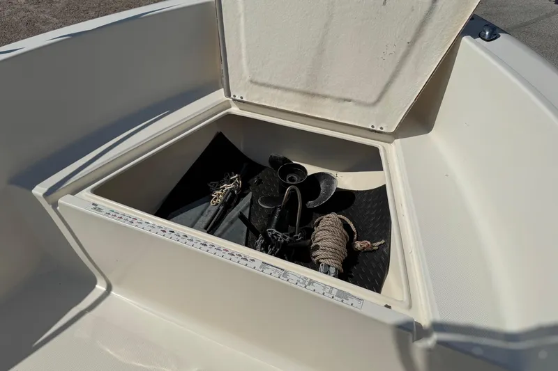 Slide: The Image of Open storage compartment on 2002 Sea Fox 236 Center Console boat with anchor and rope. - 12