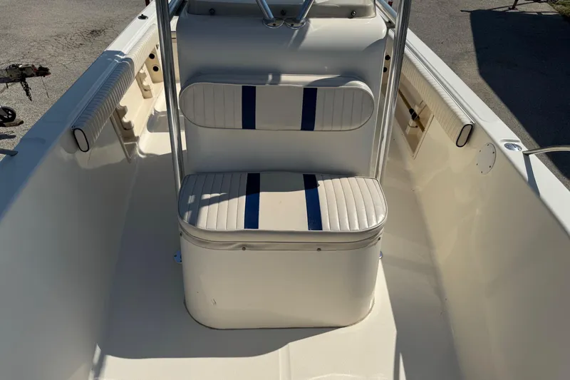 Slide: The Image of 2002 Sea Fox 236 Center Console boat interior with cushioned seating and storage. - 13