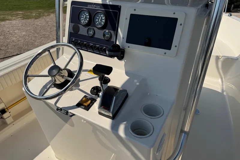 Slide: The Image of 2002 Sea Fox 236 Center Console boat dashboard with steering wheel and controls. - 19