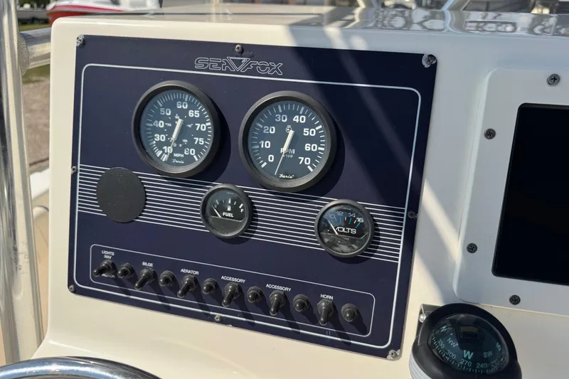 Slide: The Image of Dashboard of a 2002 Sea Fox 236 Center Console boat with gauges and controls. - 20