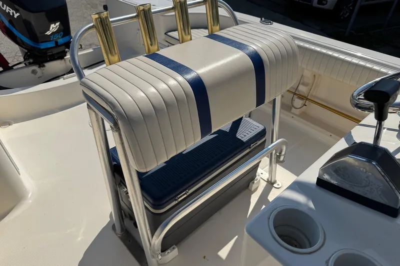 Slide: The Image of 2002 Sea Fox 236 Center Console boat interior with rod holders and seating. - 21