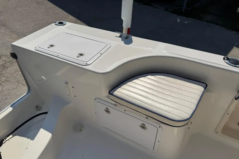 Slide: The Image of 2002 Sea Fox 236 Center Console boat interior with cushioned seating and storage compartments. - 22