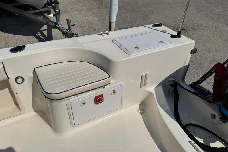 Slide: The Image of 2002 Sea Fox 236 Center Console boat interior with seating and storage compartments. - 23