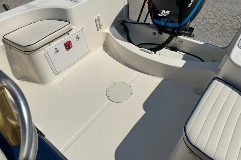 Slide: The Image of 2002 Sea Fox 236 Center Console boat interior with seating and motor. - 24