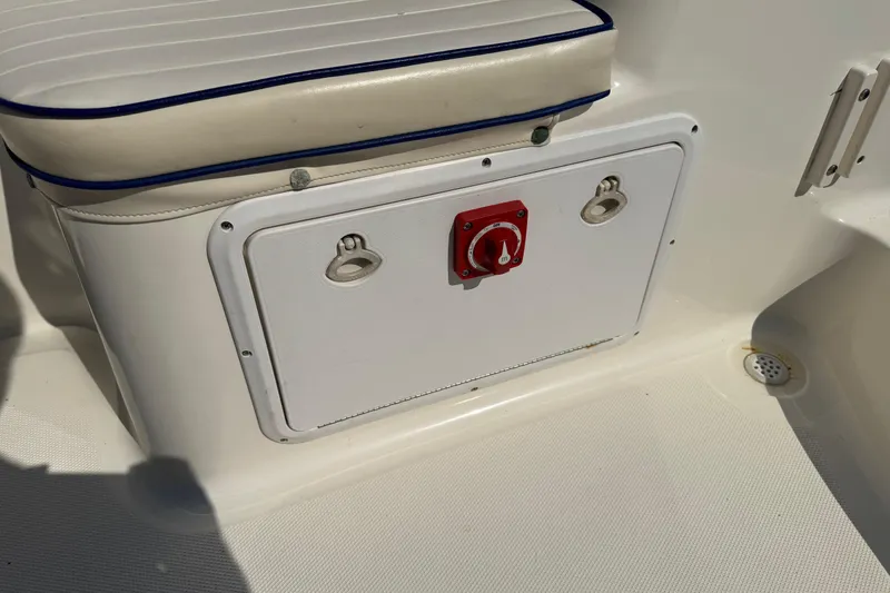 Slide: The Image of 2002 Sea Fox 236 Center Console boat seat with storage compartment and control panel. - 27