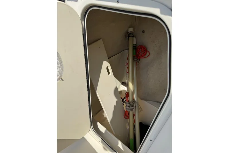 Slide: The Image of Storage compartment of a 2002 Sea Fox 236 Center Console boat with equipment inside. - 31