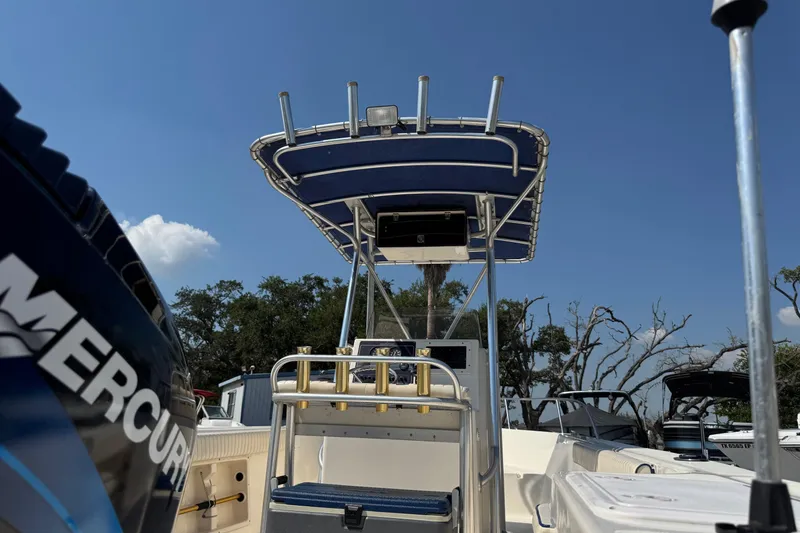 Slide: The Image of 2002 Sea Fox 236 Center Console boat with Mercury engine, under clear blue sky. - 32