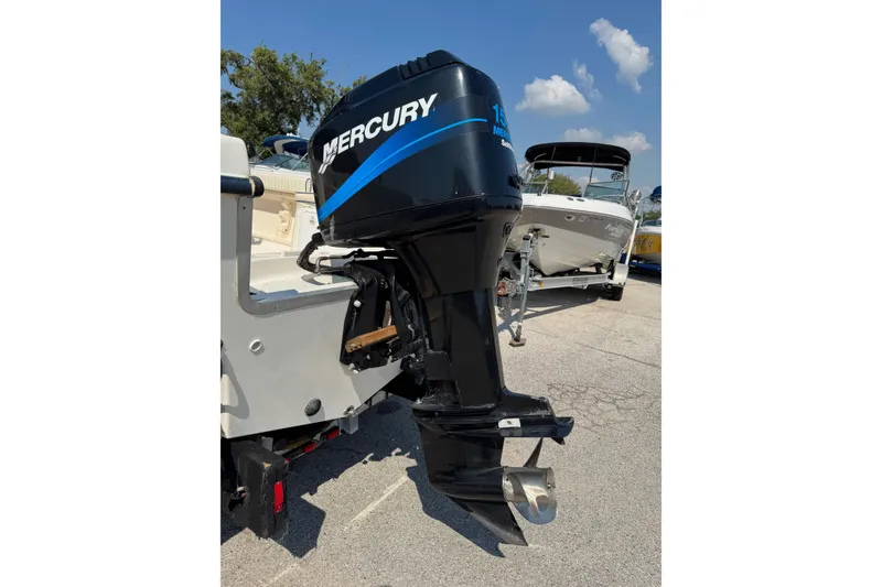 Slide: The Image of Outboard motor on a 2002 Sea Fox 236 Center Console boat, parked outdoors. - 5
