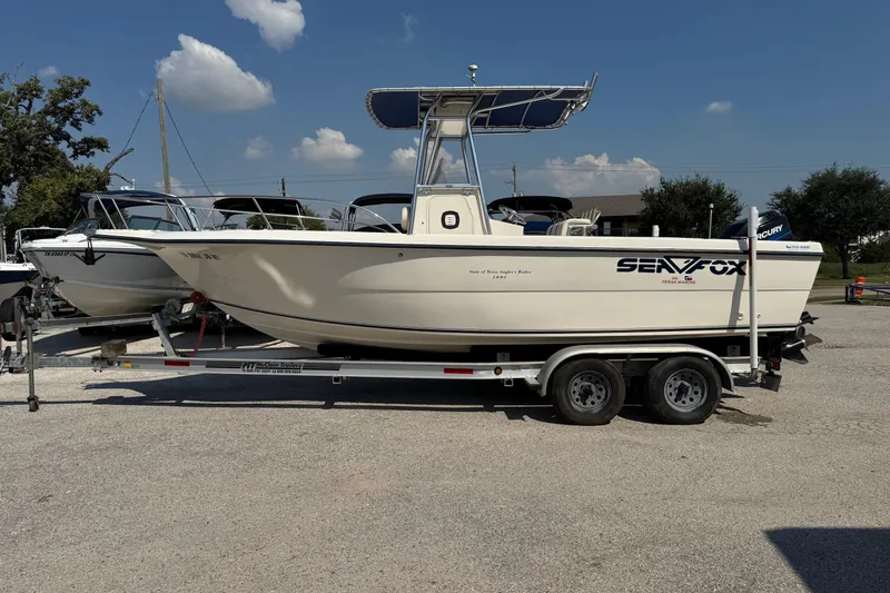 Slide: The Image of 2002 Sea Fox 236 Center Console boat on trailer under clear sky. - 9