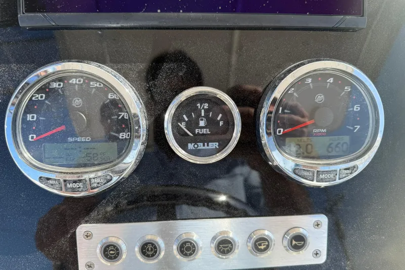 Slide: The Image of Dashboard of a 1994 Pursuit 2150 Dual Console boat with speed, fuel, and RPM gauges. - 11