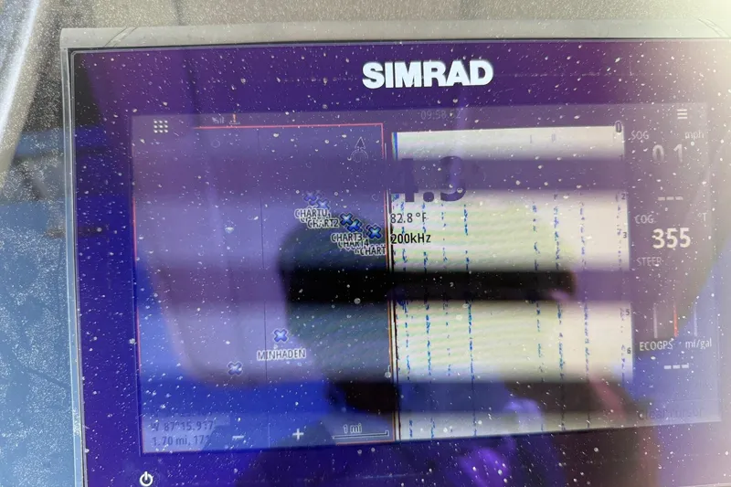 Slide: The Image of Simrad marine display on 1994 Pursuit 2150 Dual Console boat, showing navigation data. - 13