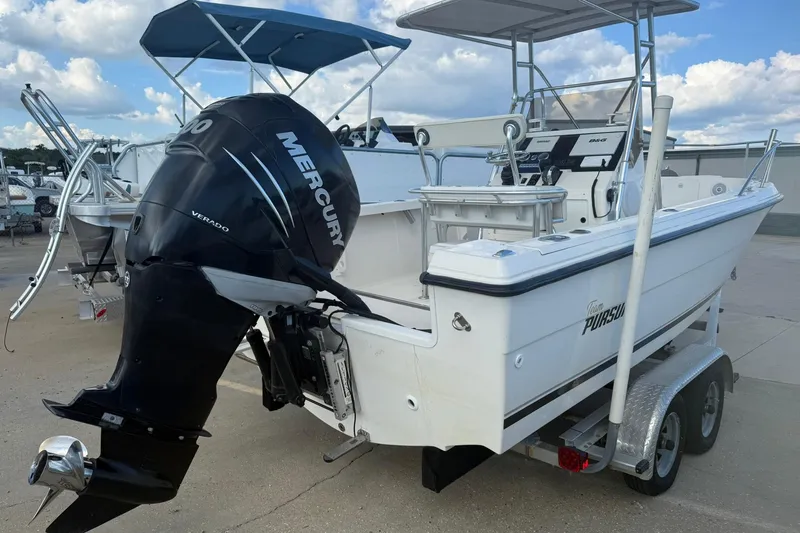Slide: The Image of 1994 Pursuit 2150 Dual Console boat with Mercury Verado engine on trailer. - 2