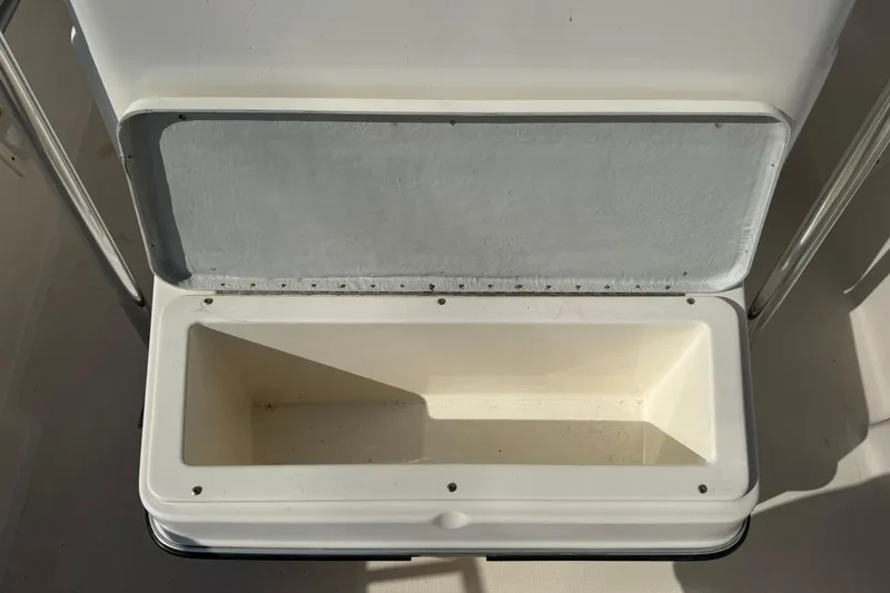 Slide: The Image of Open storage compartment on a 1994 Pursuit 2150 Dual Console boat. - 20