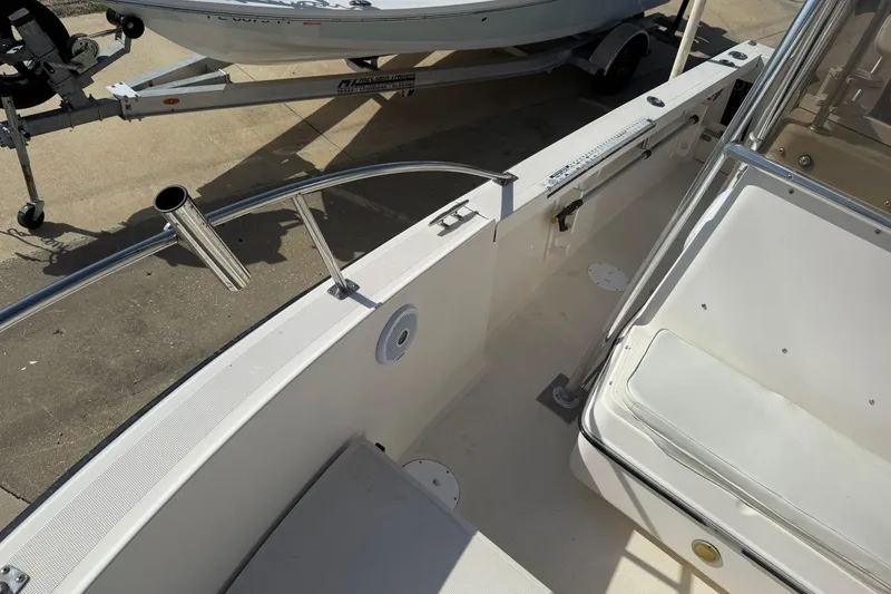 Slide: The Image of 1994 Pursuit 2150 Dual Console boat interior with seating and rod holders. - 24