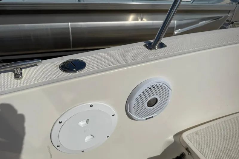 Slide: The Image of 1994 Pursuit 2150 Dual Console boat interior with speaker and railing detail. - 27