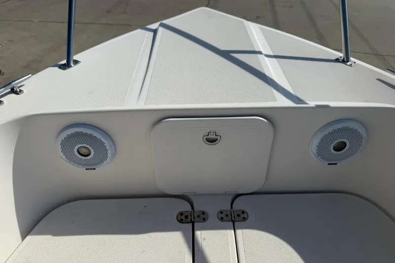 Slide: The Image of 1994 Pursuit 2150 Dual Console boat interior with speakers and storage compartment. - 28