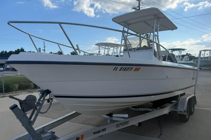 Slide: The Image of 1994 Pursuit 2150 Dual Console boat on trailer under clear sky. - 3